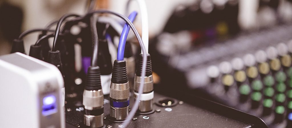 A closeup shot of plugged-in electronic cables on a blurred background