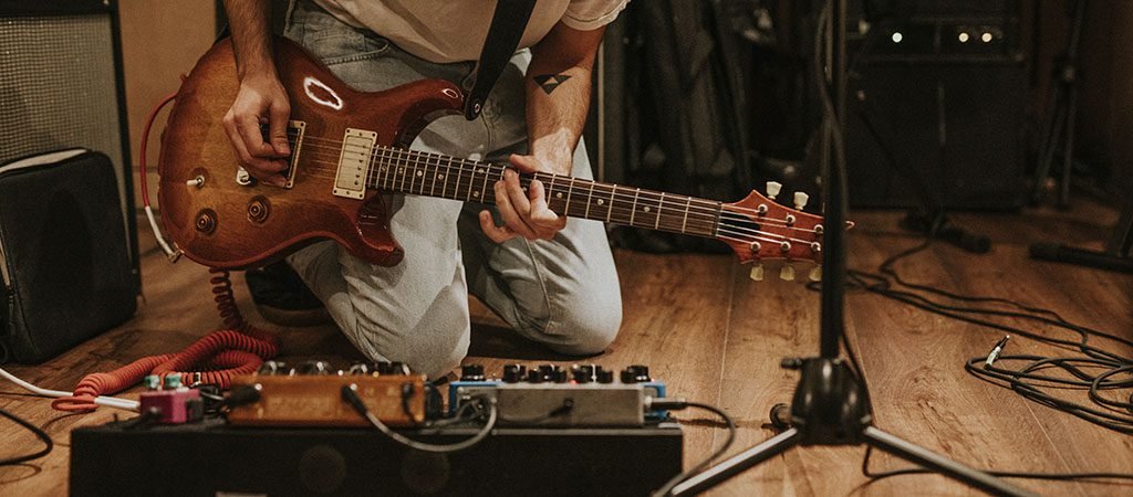 Rock band guitarist performing repetition in recording studio